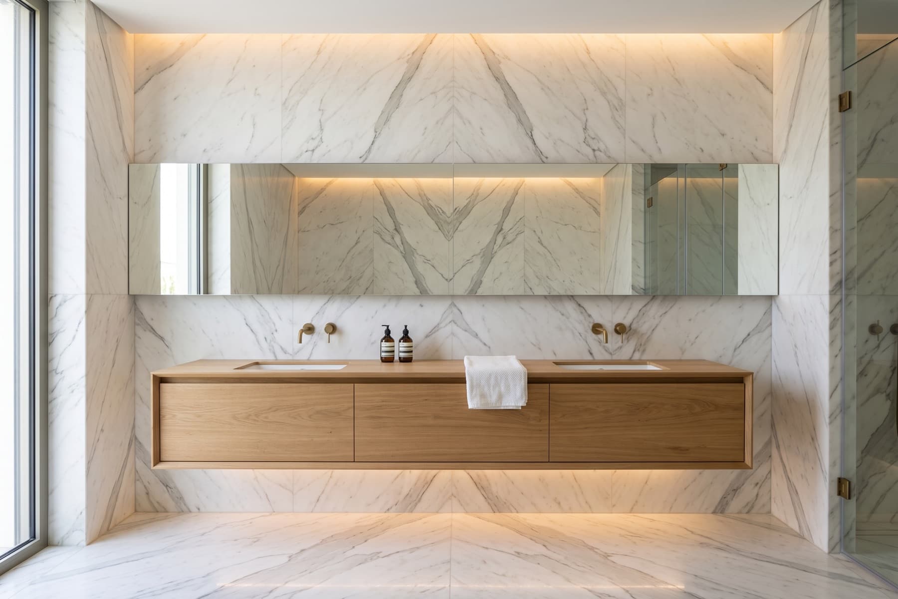 Rothschild penthouse: principal bathroom in book-matched marble