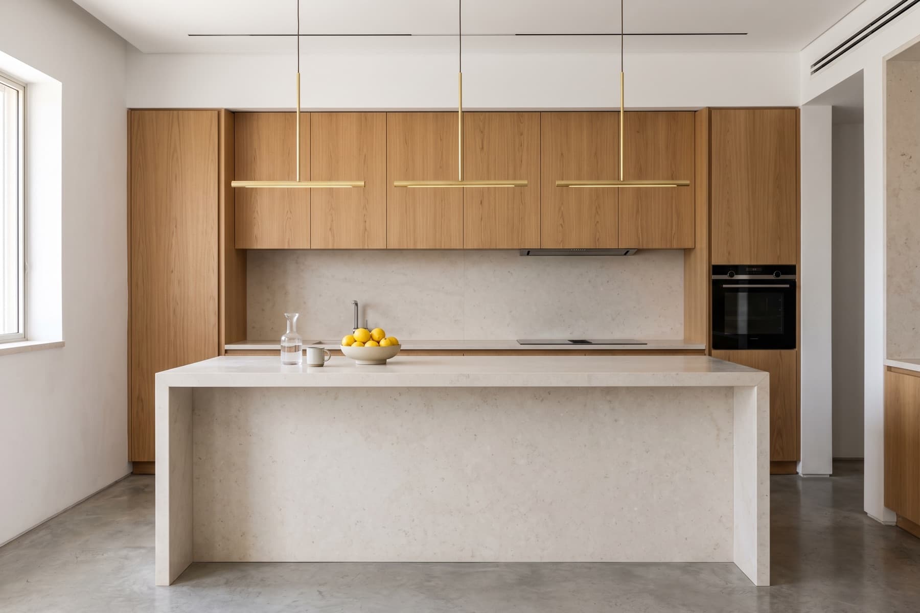 Rothschild penthouse: kitchen island in honed stone with pendant lighting